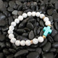 Story Stretch Bracelet: Blue Cross, Semi-Precious White Stone Beads With 18K Gold Plated Accents
