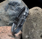 Bracelet, Mens: Cross Leather Stitched/Blk Gun (Leather, Gun Metal Cross, Magnetic Closure)