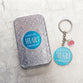 Metal Keyring in Tin: Blue, Apple, Let All That You Do Be Done in Love